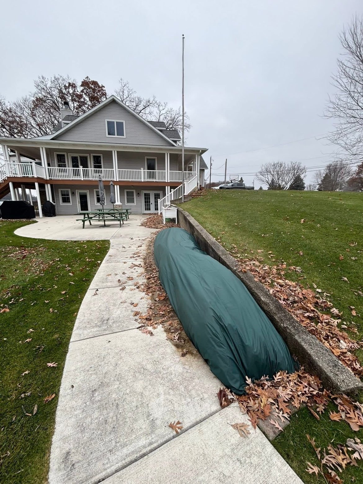 Cleaned landscape bed and patio area by Perfect Lawn Solutions.