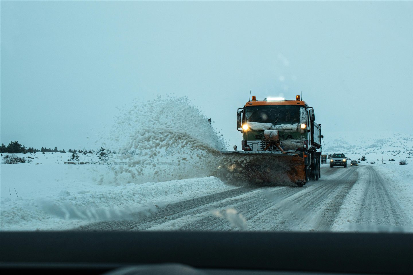 Generic snow plowing photo showing a plow truck clearing a snowy road.